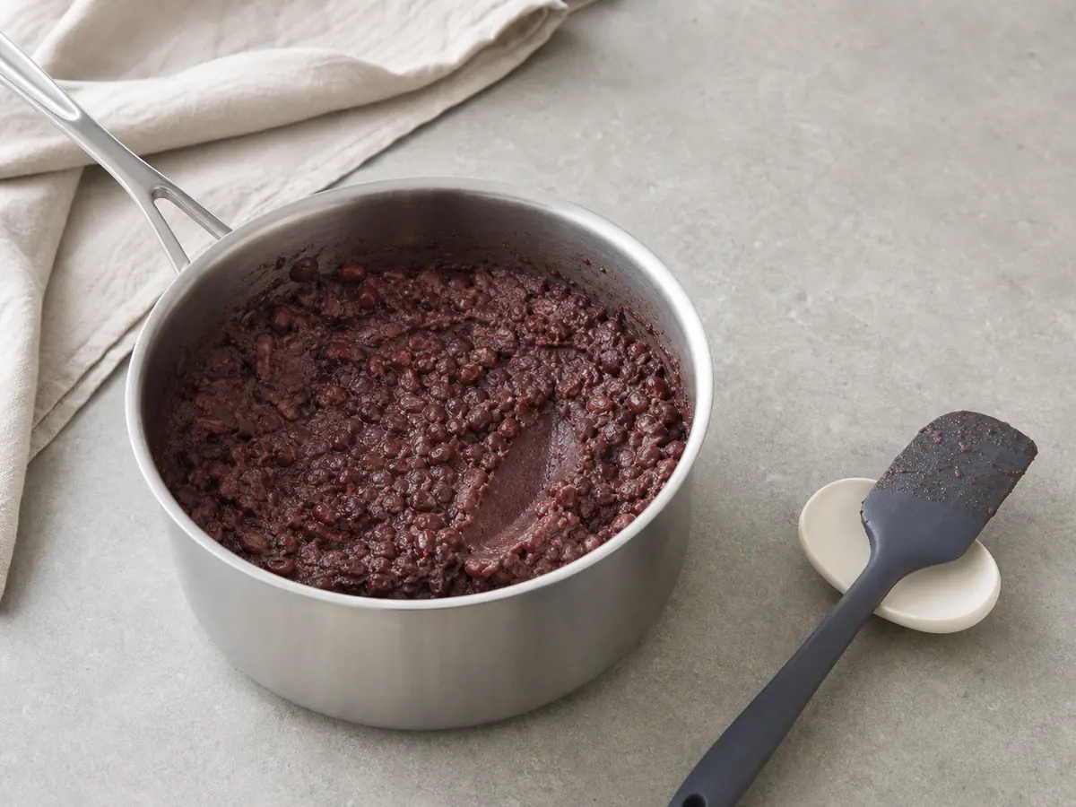Thick partly mashed sweet adzuki beans in a saucepan