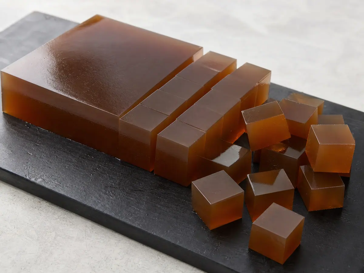 Firm amber tea jelly partly cut into small even cubes