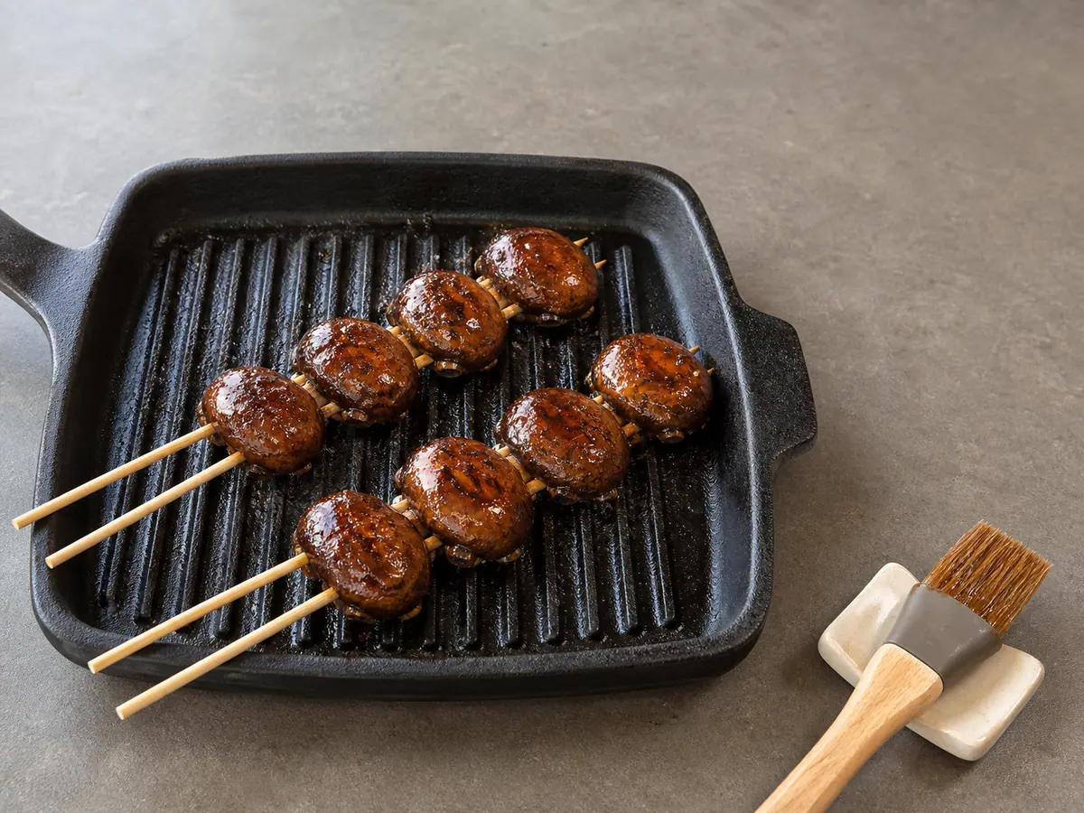 Mushroom double skewers coated with tacky caramelized teriyaki glaze in the pan